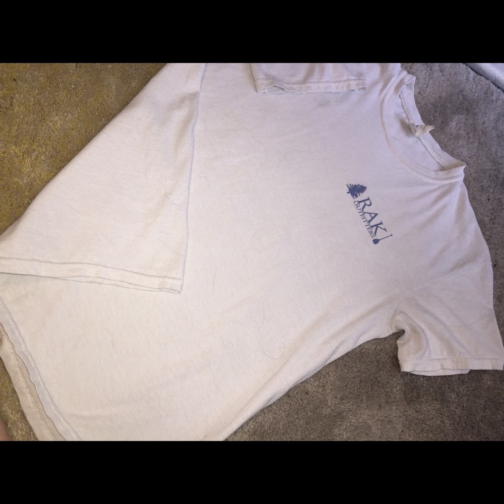 White and blue RAK shirt.